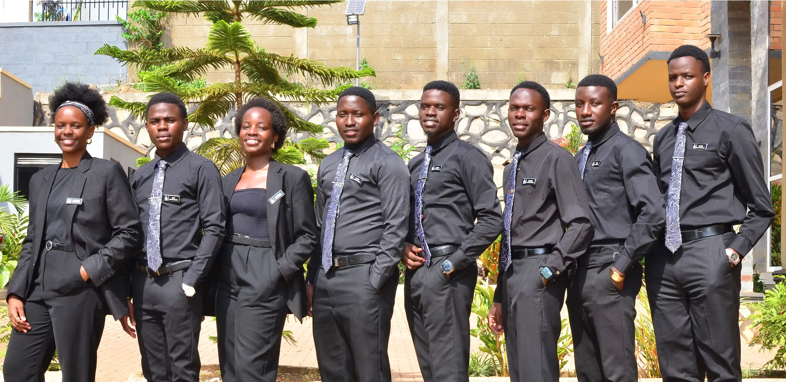 Team in black formal attire outdoors